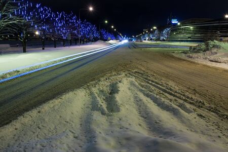 Snowy road in winter at nightの写真素材