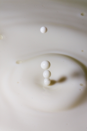 Liquid milk drop falling close upの写真素材