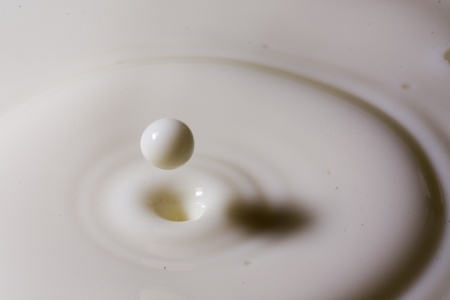 Liquid milk drop falling close upの写真素材