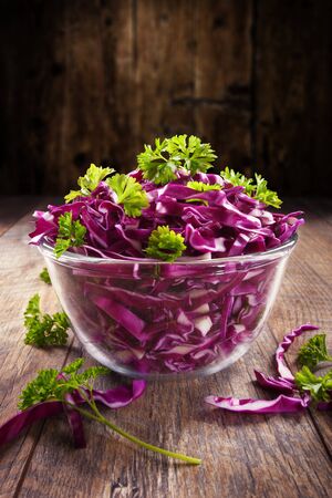Red cabbage salad with green parsley with wood backgroundの写真素材