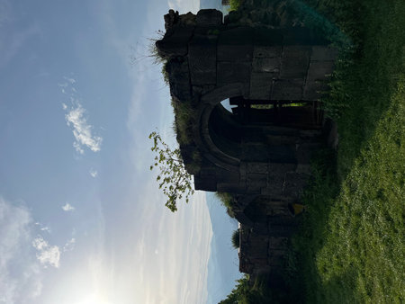 The ruins of an old castle on a green meadow in summer, somethere in Armenia