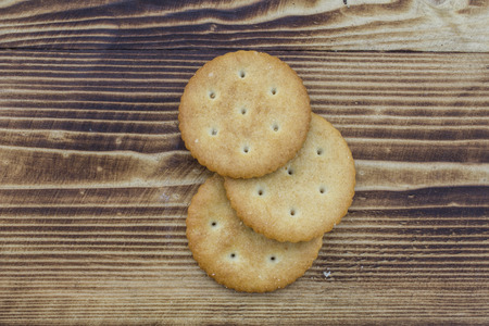 Three round cookies on a wooden backgroundの写真素材