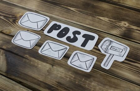 Paper sketched sketches with mail-themed letters on woodenの写真素材