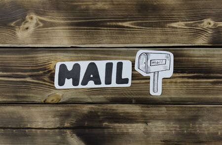 Mailbox sketch on paper and inscription wooden backgroundの写真素材