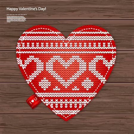 Valentines kniited heart on a wood background can be used as a greeting cardのイラスト素材