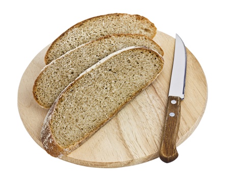 Sliced Brown Bread and a Knife on a Wooden Board isolated on a white backgroundの写真素材