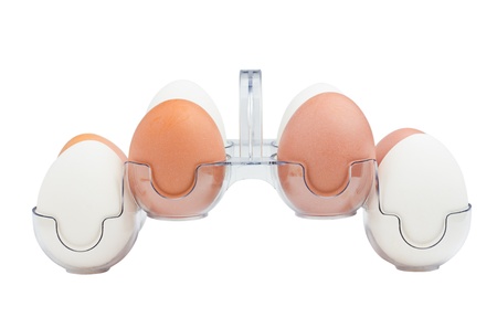 White and Brown Hen's Eggs in a Plastic Transparent Holder isolated on a white backgroundの写真素材