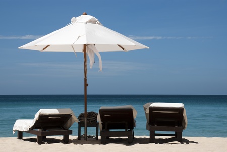 3 chairs   an umbrella on the beach in Phuket, Thailand  Image is not sharpened for future editing  のeditorial素材