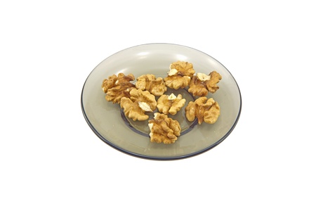 Some walnuts on a glass plate isolated on a white backgroundの写真素材