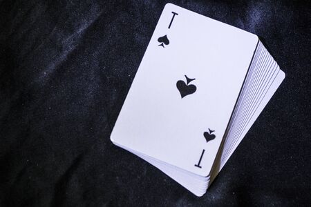 a deck of playing cards on a black background.