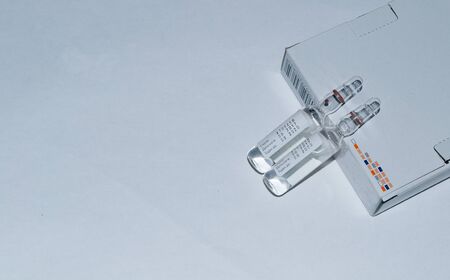 two ampoules of medicine on a white background.の写真素材