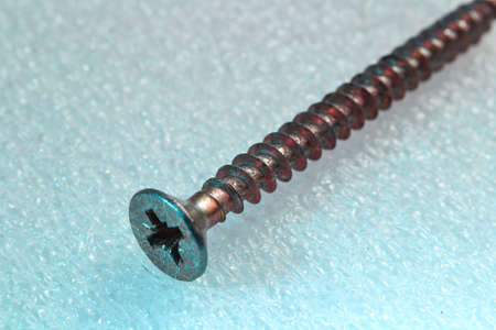 construction screw with wood carving, yellow on a white background.の写真素材