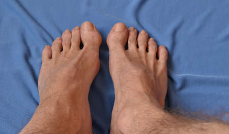 naked male legs on a blue towel.の写真素材