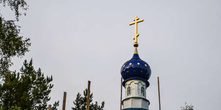 blue dome of the Church with a yellow Orthodox crossの写真素材