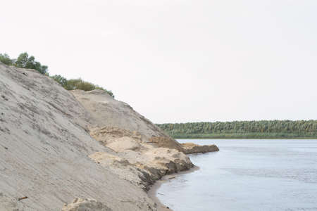 river, small ripples on the water, slow current, yellow sand Bank.の写真素材