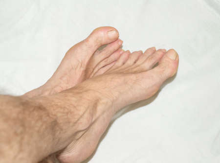 naked legs of a man on a white towel.の写真素材