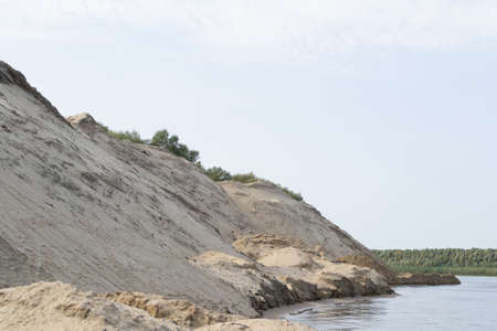 river, small ripples on the water, slow current, yellow sand Bank.の写真素材