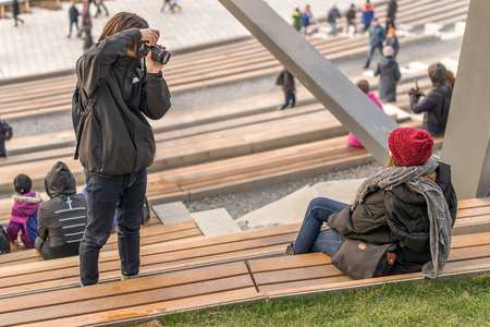 Photo shoot at the stadium, the guy takes pictures of a girl in a scarfの写真素材