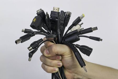 Many different connectors and wires in the hand