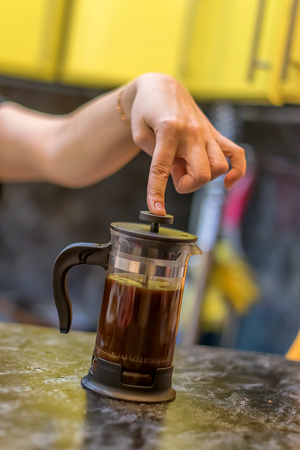 girl's hand holding and brew kettle, drink teaの写真素材