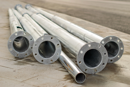 metal shiny pipes lie on the construction site