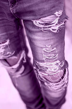 fashionable ripped jeans of blue color on the modern stylish young man, youth style in clothesの写真素材