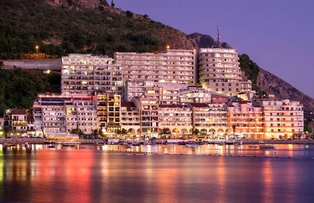 view of the night sea coast against the backdrop of mountains and sunset in the resort area with beaches and bright lights and reflected in the water. Montenegro, Budvaの写真素材
