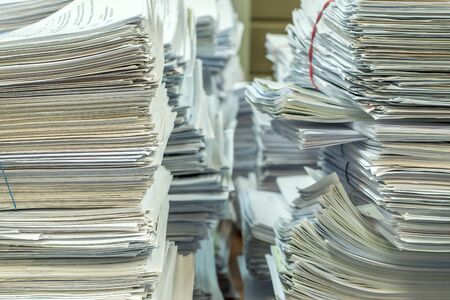 bundles bales of paper documents. stacks packs pile on the desk in the office