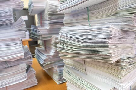 bundles bales of paper documents. stacks packs pile on the desk in the officeの写真素材