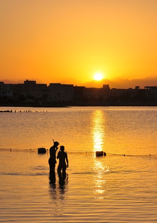 Young man and woman at sunset dive  Egypt の写真素材