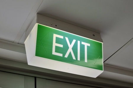A close up of an Australian green exit sign 