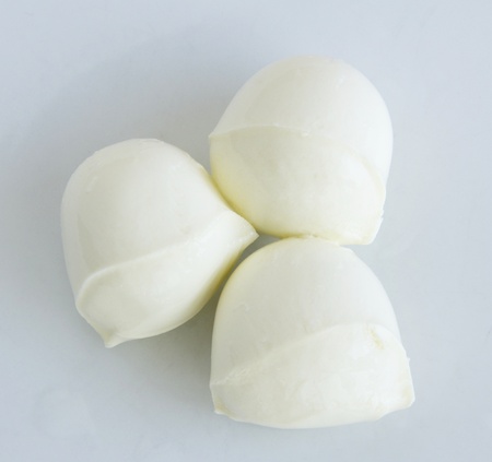Three fresh bocconcini balls of cheeseの写真素材