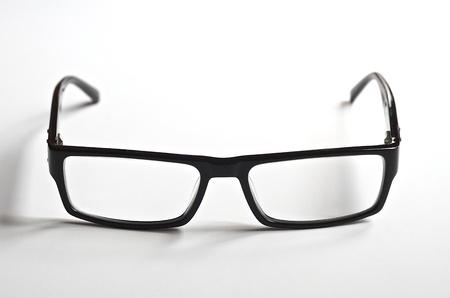 Black rimmed reading glasses on a white background の写真素材