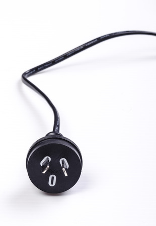 A black Australian power cord plug on white backgroundの写真素材
