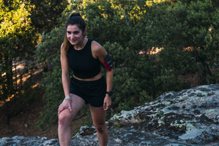 Caucasian young woman tying her shoes before trail running in the mountain. One shoe close up....