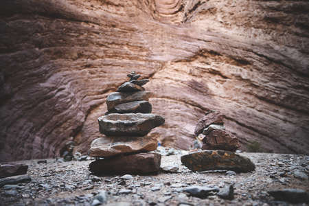 Balanced stones with a rock wall in the background. Horizontal. With copyspace.の写真素材