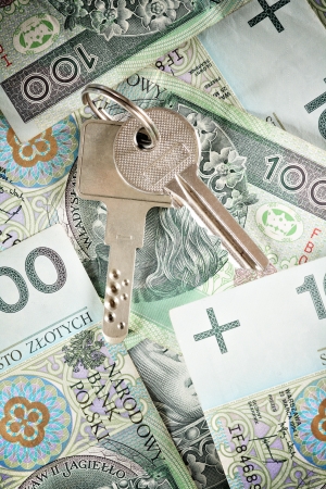 House keys on a background of banknotesの写真素材