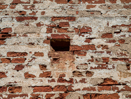 Old brick wall with a hole in it. Abstract background for design.