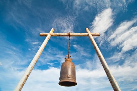 Ancient bell on the mountain with blue sky の写真素材