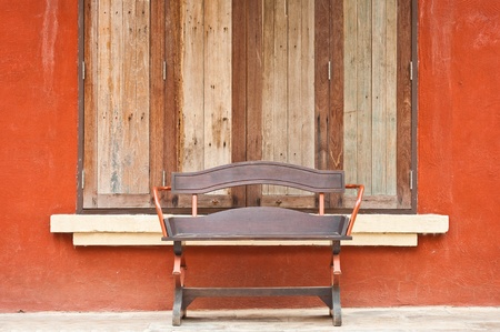 wooden chair with windows on Italian style building の写真素材