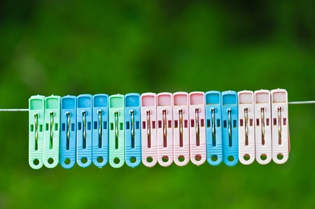 Clothespins hang on a cord の写真素材