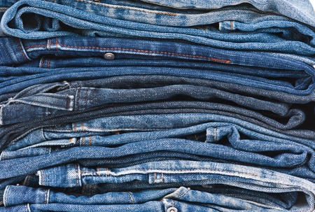 Stack of blue jeans backgroundの写真素材