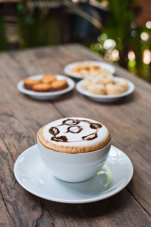 coffee cup with snack on wood tableの写真素材