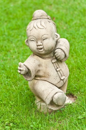 Chinese statue in the temple with grassの写真素材