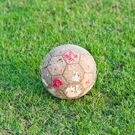 Old ball football on grassの写真素材
