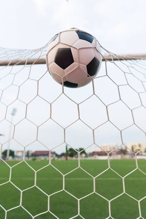 soccer ball in goal netの写真素材