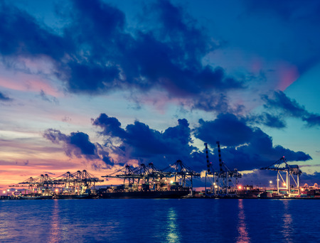 industrial port with containers at twilight - retro vintage filter effectの写真素材