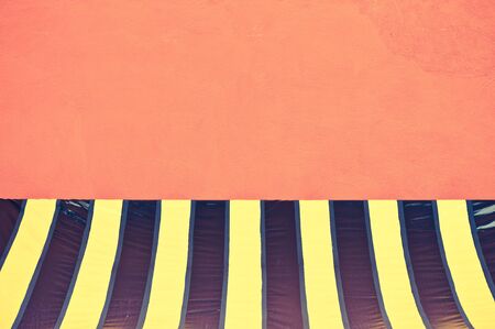 colorful plastic tent at orange wall - retro vintage filter effectの写真素材