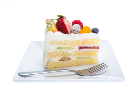 fruits cake on dish with fork isolated on white backgroundの写真素材