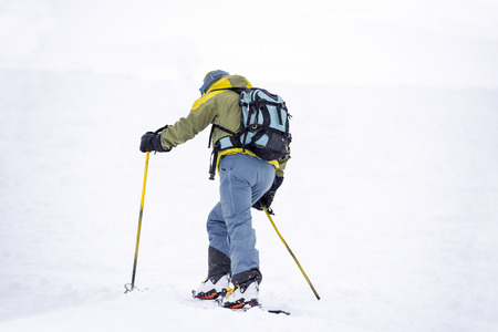 Skier climbing slopeの写真素材